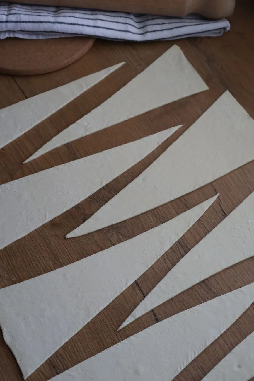 Laminated dough cut into long triangles on the bench
